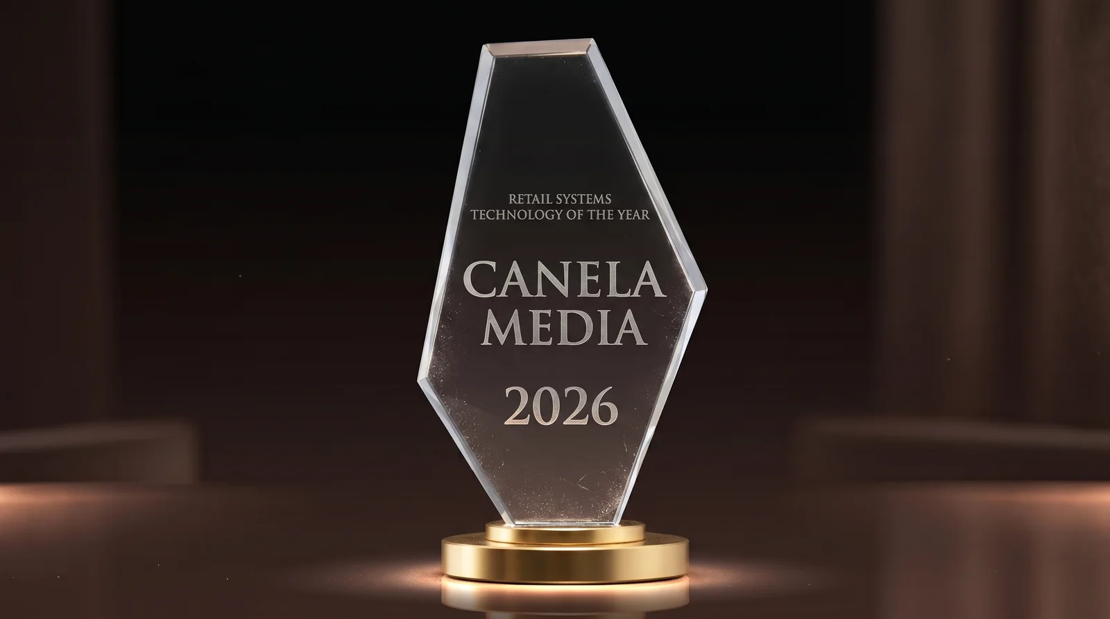 Retail Systems Technology of the Year 2026 award engraved for Canela Media, lit in gold against a dark backdrop